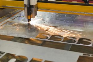 CNC laser cutting out perfect shapes from a sheet of metal